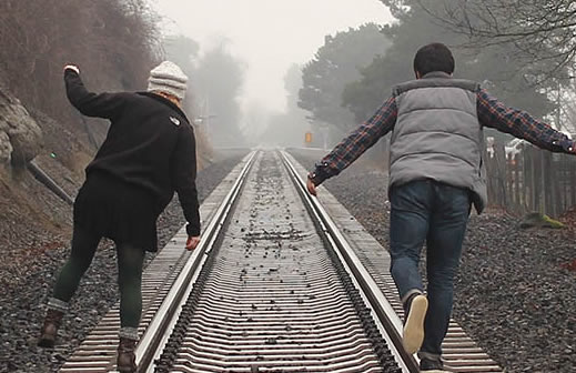 Couple Walking on a Railroad Track